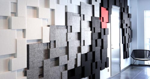 wall with gray and white felt panels for acoustical insulation